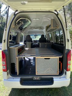 the back end of a white van with its doors open