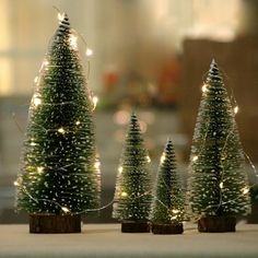 small christmas trees are sitting on a table