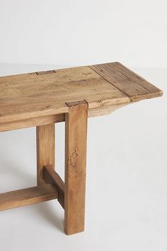 a wooden table sitting on top of a white floor