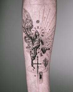 a man's leg with an angel and cross tattoo on the side of his leg