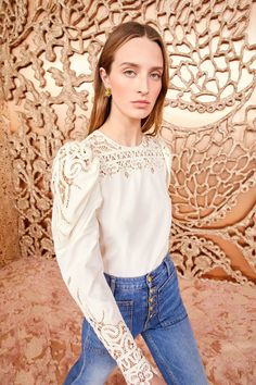 Made from our luxurious Victorian cotton-silk, the Aura Blouse is adorned with intricate Battenberg lace panels that create a decorative floral pattern along the yoke and sculptural long sleeves. It is a timeless pearly white, has a relaxed fit, and fastens with a buttoned keyhole at the back. Timeless Pearly, Battenberg Lace, Nyc Boutiques, Lace Collection, Lace Blouse Long Sleeve, Silk Lace, Signature Print, Knit Sweatshirt, Lace Panelled