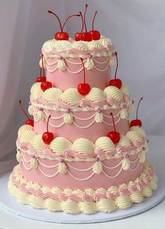 a three tiered cake with cherries on top