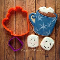 two cookie cutters, one with a mug and the other with faces