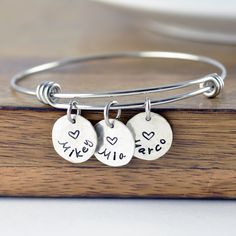 "Personalized Gift, Charm Bracelet, Name Bracelet, Gift for Her, Gift for Mom, Mothers Day Gift, Mom Gift, Mom Birthday, Kids Names This listing is for: one bangle bracelet premium stainless steel bangle this is one size fits all. and 1/2\" sterling silver name charms. ♥CONNECT WITH US♥ ✤pinterest.com/luckyhorngifts ✤facebook.com/luckyhorngifts ✤twitter.com/luckyhorngifts ✤instagram.com/luckyhorngifts" Handmade Round Charm Bracelet For Birthday, Nickel Free Name Bracelet For Friendship And Mother's Day, Charms Bracelets For Mother's Day Birthday Gift, Charms Bracelet For Birthday And Mother's Day Gift, Nickel-free Name Bracelet For Mother's Day, Adjustable Heart Bracelet For Mother's Day Birthday, Stamped Bracelets As Personalized Gift For Mother's Day, Stamped Bracelets For Mother's Day Personalized Gift, Personalized Name Charm Bracelet For Birthday And Mother's Day