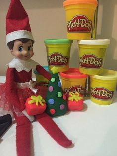 the elf is sitting next to some play - doh toys