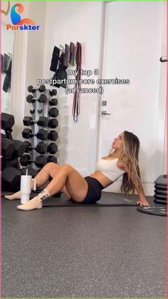 a woman laying on the floor in front of a gym equipment rack