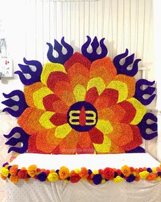 a large flower made out of flowers on top of a bed