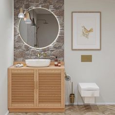 a bathroom with a round mirror and wooden cabinet in the corner, along with a toilet