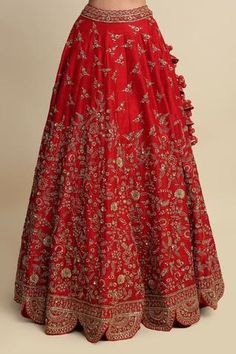 Red lehenga with hand embroidered floral motifs in zardozi and dabka work, scallop hem and tassel tie-up detailing. Paired with an open back blouse. Comes with a net embellished dupatta.
Component: 3
Pattern: Embroidered
Type Of Work: Floral motifs, Zardozi, Dabka work
Neckline: Sweetheart
Sleeve Type: Half sleeves
Fabric: Raw Silk, Net
Color: Red
Other Details: 
Scallop hem
Concealed zipper
Open back blouse
Tassel tie-up detailing
Note: The kaleeras worn by the model are not for sale.
Occasion: Red Anarkali Lehenga With Motifs, Red Semi-stitched Lehenga With Motifs, Red Lehenga With Motifs For Navratri, Red Floor-length Anarkali Set With Motifs, Red Art Silk Anarkali Set With Motifs, Red Motifs Anarkali Set For Wedding, Red Wedding Anarkali Set With Motifs, Fitted Red Anarkali Set With Motifs, Red Fitted Anarkali Set With Motifs