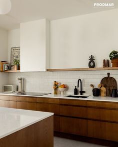 a kitchen with wooden cabinets and white counter tops