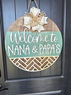 a welcome sign hanging on the front door of a house that says, welcome to nanna & papas