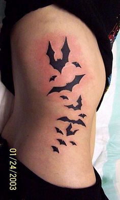 a woman's stomach with bats on it