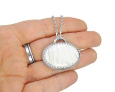 Scolecite Necklace in Sterling Silver - White Scolecite Jewelry - Pendant with Chain Quick Info: Gemstone: Natural Scolecite (25x36x7mm) Metal: Solid stamped sterling silver, heavy, thick gauge Style: Close-backed bezel with crown gallery wire and the Pepper-Stone Studio dino footprint stamp Chain: 18 inch sterling rolo chain Customers are responsible for all customs, tax, VAT, etc. charged by your region and/or country. International purchases will not be undervalued to avoid charges; this is i Dino Footprint, Pendant With Chain, Herkimer Diamond, Rolo Chain, Jewelry Pendant, Silver Diamonds, Body Jewelry, Pendant Jewelry, Jewelry Necklace Pendant