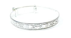 This is a Beautifully Designed Childs Claddagh Design Expandable Silver 925 Bangle..This Bangle is Crafted and designed by Irish Silversmiths and comes in a presentation box. Ideal Present for a New Born,Christening or a Present for a child. Dimensions:  Dimensions: Small      :3.5 cm expands to 4 cm  Medium:4 cm  expands to 4.5 cm  Large    :4.5 cm expands to  5 cm  Maids    :5.5 cm expands to 6 cm. Classic Adjustable Hallmarked Bangle, Sterling Silver Symbolic Adjustable Bracelet, Symbolic Sterling Silver Adjustable Bracelet, Silver Adjustable Band Bracelet As Gift, Adjustable Sterling Silver Symbolic Bracelet, Adjustable Symbolic Sterling Silver Bracelet, Silver Adjustable Band Bracelet For Gift, Classic Adjustable Charm Bangle Bracelet, Classic Adjustable Bangle Charm Bracelet