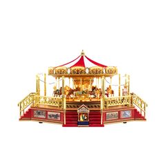 a merry go round with horses and people on the top, in red and gold