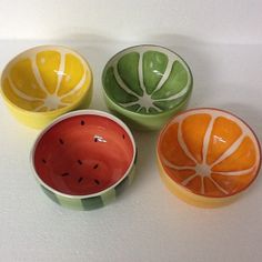 four small bowls with different designs on them