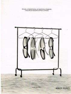 four pairs of glasses hanging on a rack