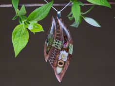 This handcrafted Persea pendant is an elegant combination of beautiful Australian Goldfield and green stabilized wood (maple burl). The result is a unique pendant with an organic but also modern and eye-catching look. The richness of the plants embedded in resin adds to this artistic jewelry even more life and colors. Each one is 100% handcrafted and one of a kind piece of jewelry. Jewelry bail - silver 925. Chain is not included. Nature-inspired Brown Pendant Necklace, Brown Nature-inspired Pendant Necklace, Unique Brown Jewelry With Natural Variations, Unique Brown Jewelry With Inlay, Nature-inspired Brown Jewelry With Natural Variations, Brown Pendant Jewelry With Natural Inclusions, Nature-inspired Brown Pendant Jewelry, Artisan Brown Jewelry With Natural Inclusions, Nature-inspired Necklace With Large Oval Pendant