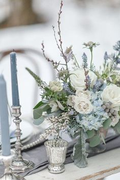 the table is set with flowers and candles for an elegant wedding breakfast or brunch