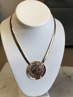 "METAL: 14kt and 18kt Solid Yellow Gold LENGTH: 16 inches WIDTH: 5mm WEIGHT: 30.4 grams CLOSURE: Hidden Box Clasp with Fig 8 safety closure. This custom-made Pendant has beautiful designs of Greek symbols on an 1 3/4\" diameter Disc Plaque. Chain is a 5mm Beveled Herringbone Chain in 16\". FREE SHIPPING Regular Retail Price: $4,789.00" Luxury Collectible Medallion Necklace, Luxury Yellow Gold Chain Necklace With Round Pendant, Designer Gold-tone Tarnish Resistant Jewelry, Luxury Yellow Gold Necklace With Round Pendant, Designer Gold Jewelry With Polished Finish, Designer Polished Gold Jewelry, Designer Tarnish-resistant Gold-tone Jewelry, Luxury Collectible Round Necklace, Luxury 14k Gold Chain Necklace In Gold-tone