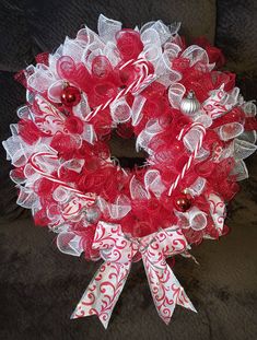 a red and white christmas wreath with candy canes