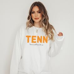 This adorable sweatshirt comes in black and sand sweatshirt colors. This cozy sweatshirt is great for college students, Tennessee Sports fans, Tennessee gift, Tennessee Travel Gift, Game Day Outfit, Tennessee Sports Gift, and Fall Outfits, and more! Ideal for any Tennessee Fan, a unisex heavy blend crewneck Tennessee Home Sweet Home to Me sweatshirt is pure comfort. These garments are made from polyester and cotton. This combination helps designs come out looking fresh and beautiful. The collar White Long Sleeve Sweatshirt With School Spirit, White Collegiate Sweatshirt For Fall, White Sweatshirt With Ribbed Cuffs For Campus, White Relaxed Fit Sweatshirt For Campus, White Fall College Sweatshirt, White College Sweatshirt For Fall, Long Sleeve Text Print Sweatshirt For Sports Season, Oversized School Spirit Sweatshirt For Campus, White Sporty Sweatshirt For Campus