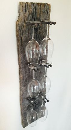 several wine glasses are hanging on a wall