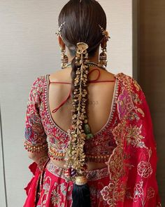 the back of a woman's head wearing a red dress with gold and black details