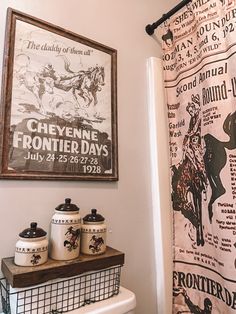 a bathroom with a shower curtain that has an old poster on the wall above it