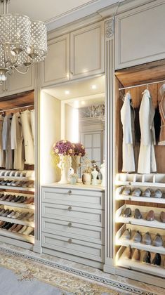 a walk in closet with chandelier and shoes