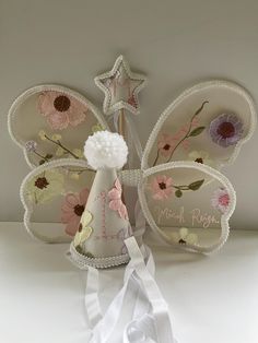 a white and pink butterfly decoration on top of a table