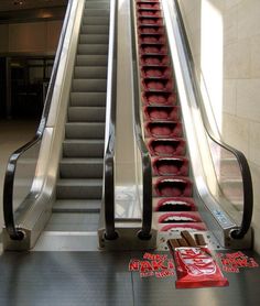 an escalator with red seats on it and some signs attached to the railing