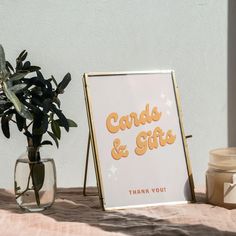 there is a sign that says cards and gifts next to a vase with a plant