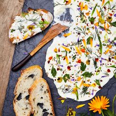 an assortment of breads and flowers on a table