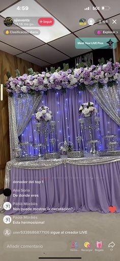 the wedding stage is decorated with purple and white flowers