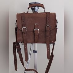 Dimension: 16 * 11 * 5.8"; Weight 5.8 Lb. Internal Laptop Compartment Dimension 15.5 * 9.2" Internal 2 Large Pockets With 3 Pen Holders, Key Lock String Classic Saddle Style, 3 Front Straps, Backpack Option 2 Large Side Pockets, Large Back Pocket With Luggage Hold Strap This Is A Soft Full Grain Leather Bag That Can Be Carried As A Case Or Over The Shoulder. The Case Is Naturally Distressed And Has Not Been Used. The Store Tag Is The Leather Tag Shown In The Picture. Rugged Leather Satchel With Adjustable Strap, Leather Saddle Satchel For Everyday Use, Full Grain Leather Bag, Leather Tag, Key Lock, Pen Holders, Full Grain Leather, Back Pocket, The Store