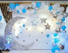 a decorated stage with balloons, stars and moon in the middle for a birthday party