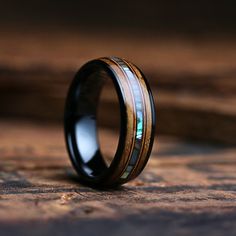 a wedding ring with an opal and wood inlays on the inside of it