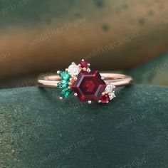 a red and green ring sitting on top of a rock