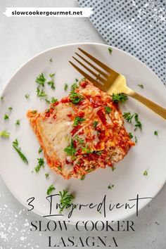 a white plate topped with lasagna covered in sauce and parsley