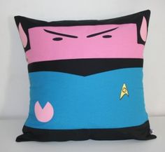 a pink and blue pillow with a star trek character on it's face is sitting in front of a white wall