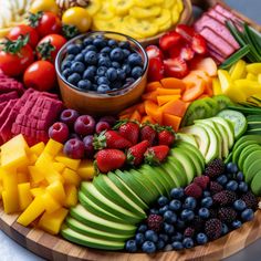 a wooden platter filled with fruit and veggies