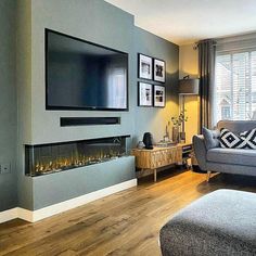 a living room with grey walls and wood floors