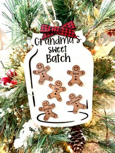 a christmas ornament hanging from a tree with gingerbreads and snowflakes