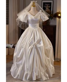 Buy ruffled ballgown satin vneck wedding dress with bubble sleeves at wholesale price online. Free shipping and pro custom service since 2009. Satin Ball Gown With Ruffles For Wedding, Wedding Satin Ball Gown With Ruffles, Satin V-neck Ball Gown For Wedding, V-neck Satin Ball Gown For Wedding, Satin Wedding Gown With Ruffles, Vneck Wedding Dress, Delicate Gown, V Neck Wedding Dress, Standard Dress