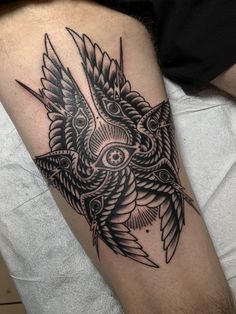 a black and white tattoo on the leg of a man with an owl design around his arm