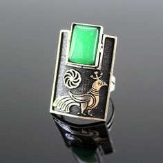 Silver ring with Armenian infinity sign and peacock pattern. The shape is classic, rectangular. She grabs finger very nicely. At the top of the ring is natural chrysolite. The ring is quite large with an interesting design.The ornament is copied from ancient Armenian national drawings.Author's handwork.Ring size - 3,5*2 cm.Ring weight - 10 g. Modernist Handmade Rectangular Jewelry, Unique Green Rectangular Rings, Unique Green Rectangular Jewelry, Modernist Green Ring As A Gift, Green Modernist Ring As A Gift, Modernist Green Ring For Gift, Green Modernist Ring As Gift, Hallmarked Rectangular Emerald Ring, Modernist Green Rings For Gift