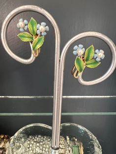 "This beautiful dainty pair of earrings are marked Krementz.  Each earring has 3 green metal enamel leaves with 2 forget me not florals with a semi cultured pearl in each center.  The earrings have a gold overlay and screw back mechanisms.  This set is in perfect condition.  Measurement 3/4\" x 3/4\" Item will be gift wrapped and shipped free of charge." Kremetz Jewelry, Green Metal, Gold Overlay, Forget Me Not, Screw Back Earrings, Cultured Pearls, Estate Jewelry, Screw, Jewelry Earrings