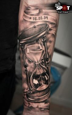 a man with a tattoo on his arm that has an hourglass in it