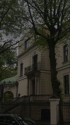 an old building with a tree in front of it